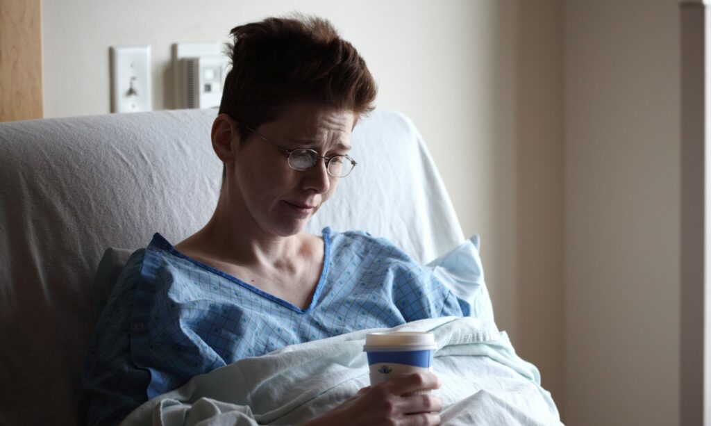 My wife about 18 hours after her right hemicolectomy surgery, drinking broth.
